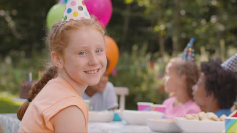 Portrait-of-Young-Girl-Smiling-to-Camera-at-Outdoor-Birthday-Party