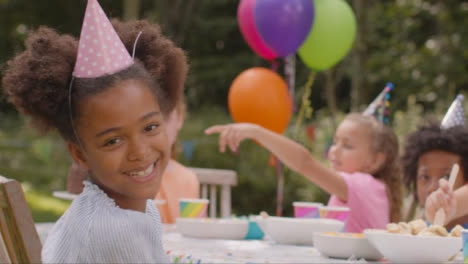 Portrait-of-a-Young-Girl-Smiling-to-Camera-at-Outdoor-Birthday-Party