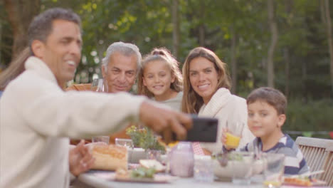 Tracking-Shot-of-Family-Taking-a-Selfie-at-Outdoor-Dinner-Table-01
