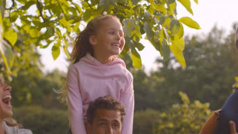 Tracking-Shot-of-Children-Sitting-On-Their-Parents-and-Grandparents-Shoulders-01