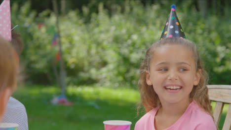 Over-the-Shoulder-Shot-of-Child-Birthday-Party-Guest-Talking-to-Friends