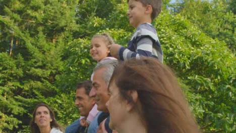 Tracking-Shot-of-Children-Riding-On-Their-Family's-Shoulders-02