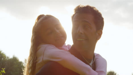 Portrait-Shot-of-Young-Girl-Getting-Piggy-Back-from-Her-Father-01