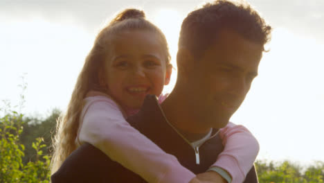 Portrait-Shot-of-Young-Girl-Getting-Piggy-Back-from-Her-Father-02