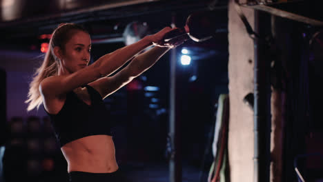 Slow-Motion-Of-Determined-Female-Athlete-Doing-Exercise-With-Kettlebell-During-Fitness-Training