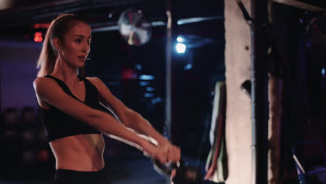 Slow-Motion-Of-Dedicated-Young-Woman-Doing-Exercise-With-Kettlebell-In-Gym