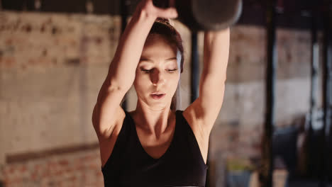 Slow-Motion-Of-Determined-Young-Female-Athlete-Doing-Exercise-With-Kettlebell