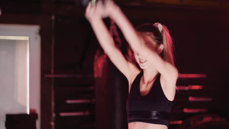 Confident-Slim-Female-Athlete-Doing-Exercise-With-Kettlebell-During-Fitness-Training