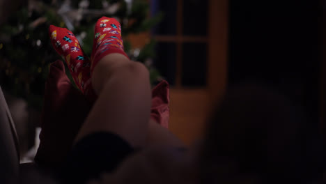 Young-Woman-Wearing-Warm-Wool-Socks-Lying-By-The-Fireplace-At-Christmas-Eve-7