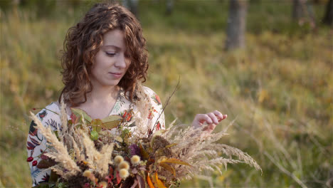 Medium-Shot-Of-Woman-Looking-At-Bouquet-Of-Wild-Flowers-In-Summer-2