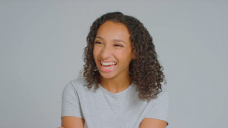 Portrait-Shot-of-Young-Adult-Woman-Laughing-at-Something-Off-Camera