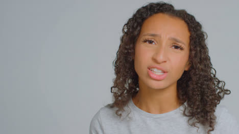 Portrait-Shot-of-Angry-Adult-Woman-Shouting-to-Camera-with-Copy-Space