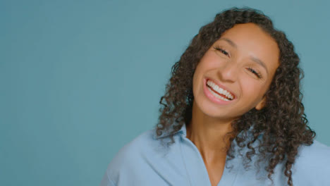 Portrait-Shot-of-Young-Adult-Woman-Laughing-to-Camera-with-Copy-Space