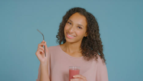 Portrait-Shot-of-Young-Adult-Woman-Placing-Straw-In-Smoothie-