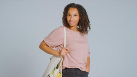 Portrait-Shot-of-Young-Adult-Woman-with-Bag-of-Fruit-and-Vegetables