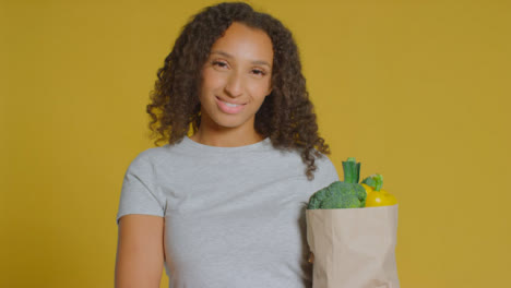 Portrait-Shot-of-Young-Adult-Woman-with-Brown-Paper-Bag-of-Vegetables-01