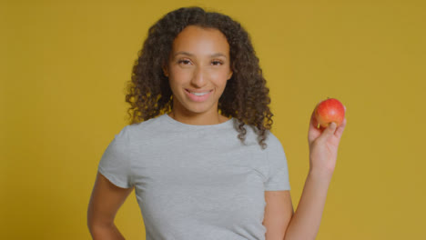 Portrait-Shot-of-Young-Adult-Woman-Holding-Apple