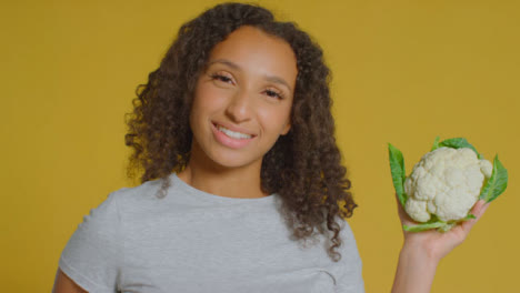 Portrait-Shot-of-Young-Adult-Woman-Holding-Cauliflower