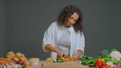 Wide-Shot-of-Young-Adult-Woman-Slicing-Carrot