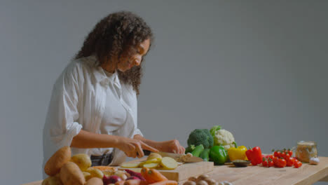 Wide-Shot-of-Young-Adult-Woman-Slicing-Mushroom