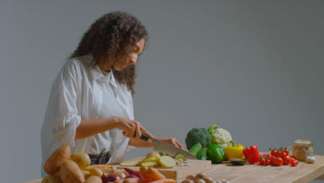 Wide-Shot-of-Young-Adult-Woman-Slicing-Courgette
