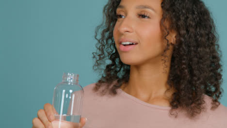 Close-Up-Shot-of-Young-Adult-Woman-Drinking-from-Water-Bottle-02