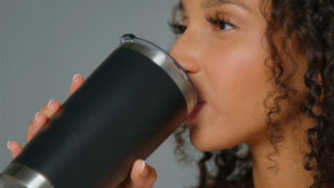 Close-Up-Shot-of-Young-Adult-Woman-Drinking-from-Flask-02
