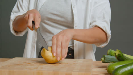 Tracking-Shot-of-Young-Adult-Woman-Slicing-Potato-02