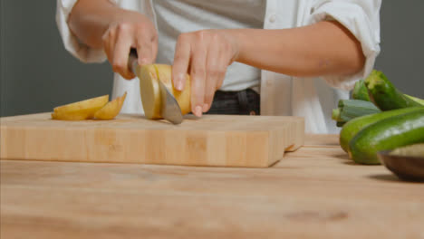 Tracking-Shot-of-Young-Adult-Woman-Slicing-Potato-03
