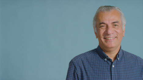 Portrait-Shot-of-Senior-Man-Smiling-and-Laughing-to-Camera-with-Copy-Space