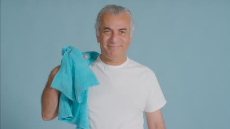 Portrait-Shot-of-a-Senior-Man-Throwing-Towel-Over-His-Shoulder