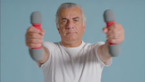 Portrait-Shot-of-a-Senior-Man-Using-Weights