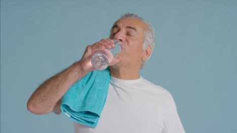 Portrait-Shot-of-Senior-Man-Drinking-from-Plastic-Water-Bottle