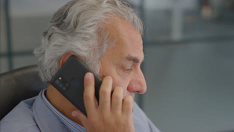 Close-Up-Shot-of-Senior-Man-Talking-On-Mobile-Phone