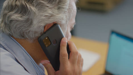Close-Up-Shot-of-Senior-Man-Talking-On-His-Mobile-Phone