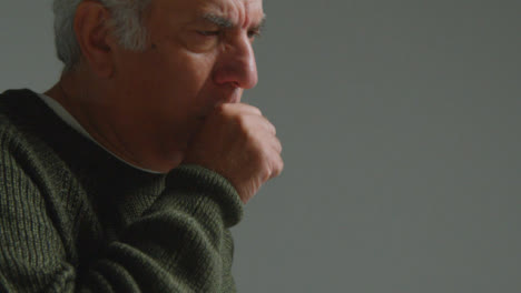 Close-Up-Shot-of-Senior-Man-Coughing-into-His-Elbow