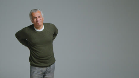 Wide-Shot-of-Senior-Man-Experiencing-Severe-Back-Pain