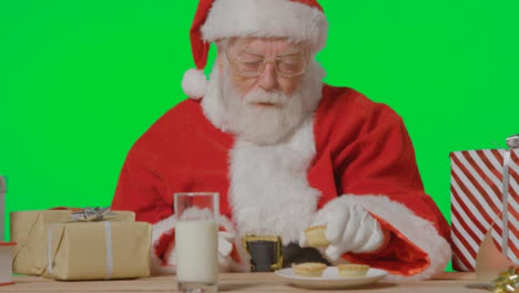 Portrait-Shot-of-Santa-Pulling-a-Plate-of-Mince-Pies-to-Him