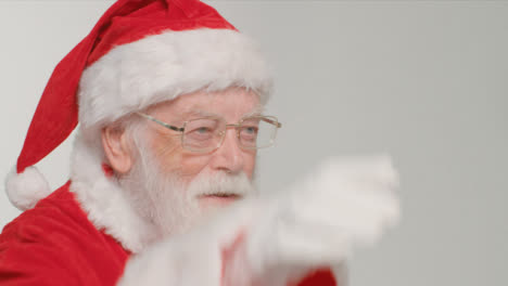 Close-Up-Shot-of-Santa-Waving-and-Looking-Off-Camera