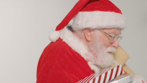 Close-Up-Shot-of-Santa-Walking-Into-and-Out-of-Frame-Holding-Presents