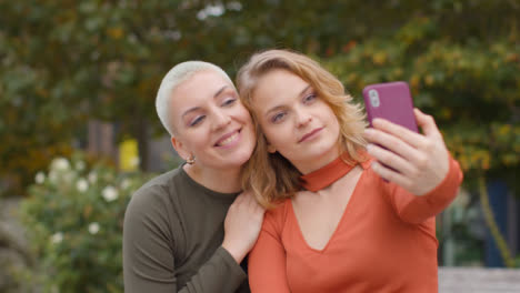Close-Up-Shot-of-Two-Friends-Taking-Selfies