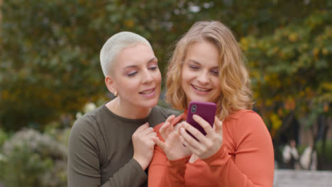 Close-Up-Shot-of-Two-Female-Friends-Taking-Selfies
