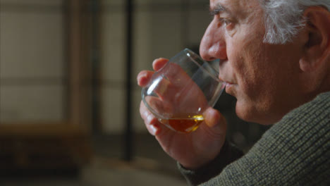 Tracking-Shot-Approaching-a-Senior-Man-Drinking-Whiskey