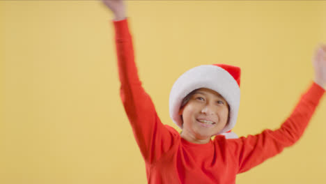 Young-Boy-in-Santa-Hat-Waves-Arms