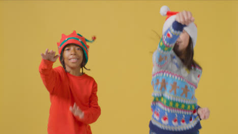 Two-Boys-in-Festive-Outfits-Dancing-to-Camera