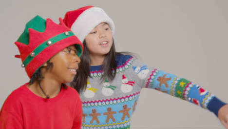Side-Profile-of-Two-Boys-in-Christmas-Outfits-Dancing