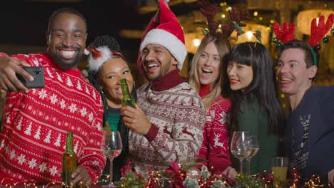 Sliding-Shot-of-Friends-Taking-a-Group-Photo-During-Christmas-Celebrations