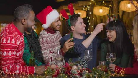 Medium-Shot-of-Drunk-Man-with-His-Friends-During-Christmas-Celebrations-at-Bar