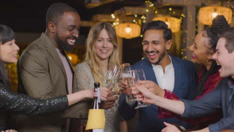 Sliding-Shot-of-Friends-Toasting-Champagne-During-New-Years-Celebrations-In-a-Bar