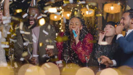 Sliding-Shot-of-Friends-Celebrating-New-Years-Eve-with-Confetti